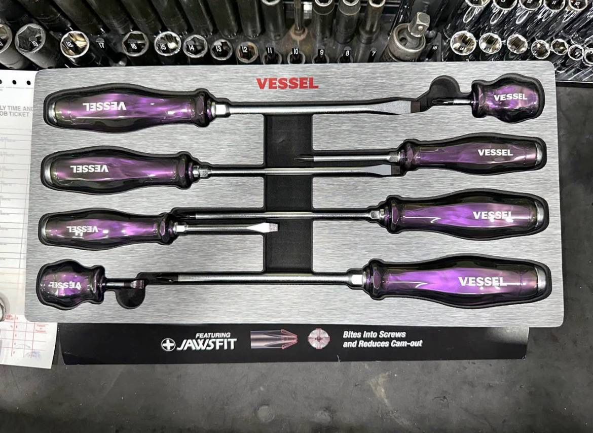 Vessel Iridescent Limited Edition Screwdriver with rainbow PVD coating and black Megadora ball grip handle on a workbench.vessel iridescent limited screw drivers